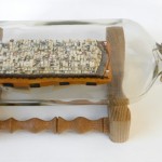 Mobro (Garbage Barge), 2010, glass, wood, paper, paint, gold chain, 6x12x5 inches 